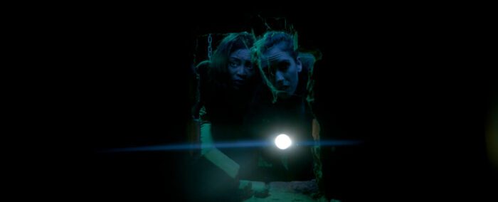 Two women looking into a hole