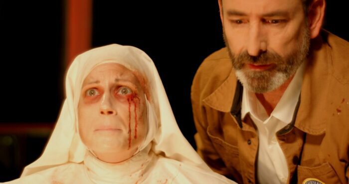 A man and a nun with blood on her face