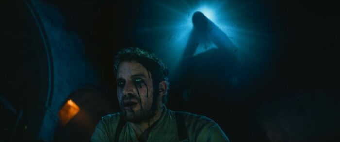 A man with a bloody face and Valak behind him