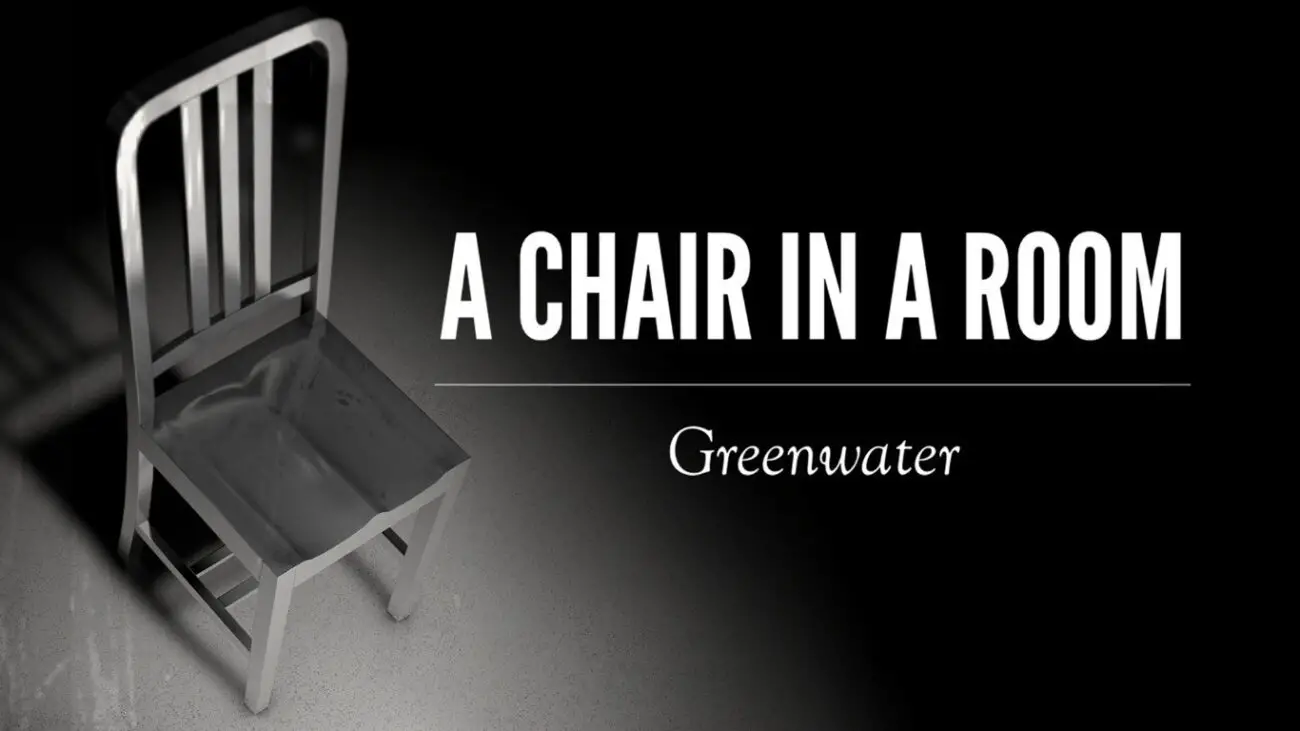 A simple, eerie image of a metallic chair casting a shadow on the floor. The title "A Chair in a Room: Greenwater" is displayed prominently in white text against a black background.