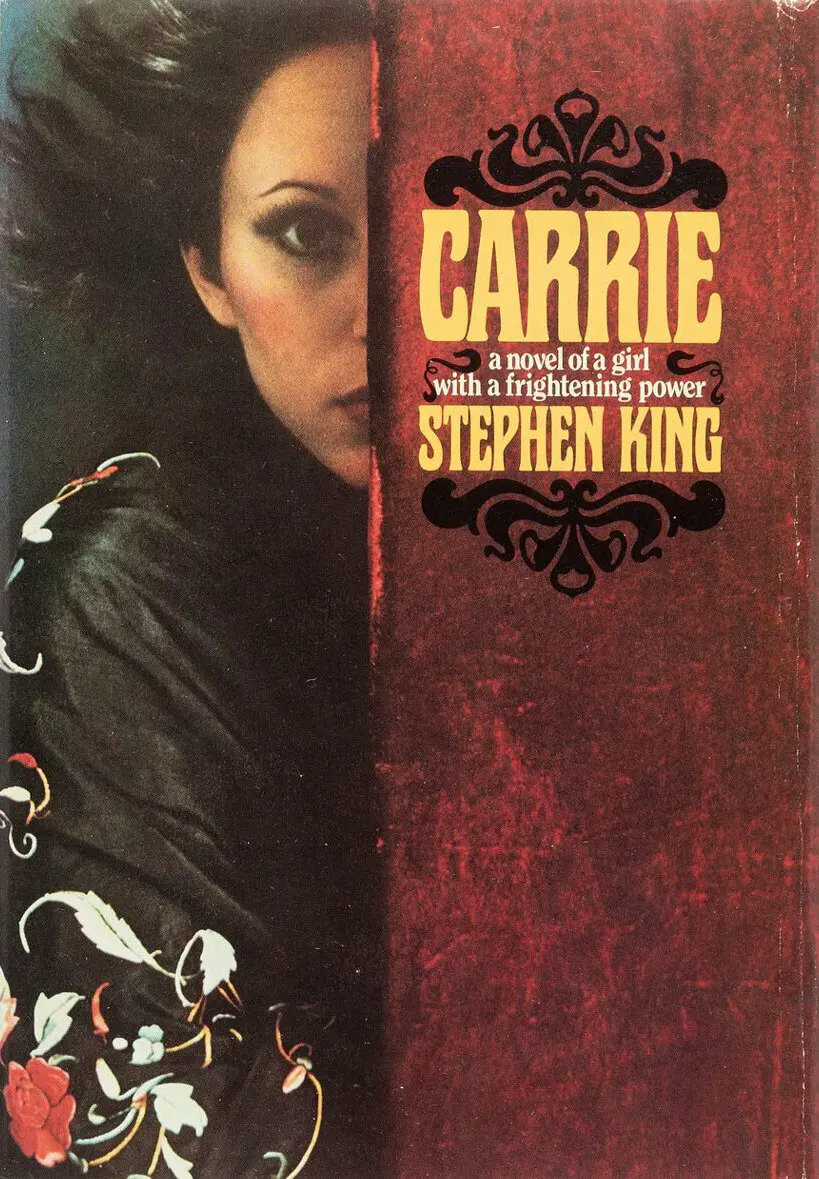The original dust jacket of Stephen King’s 1974 novel "Carrie," featuring a haunting illustration of a girl half-hidden behind a red curtain. This iconic cover introduced the world to the chilling story of Carrie White.