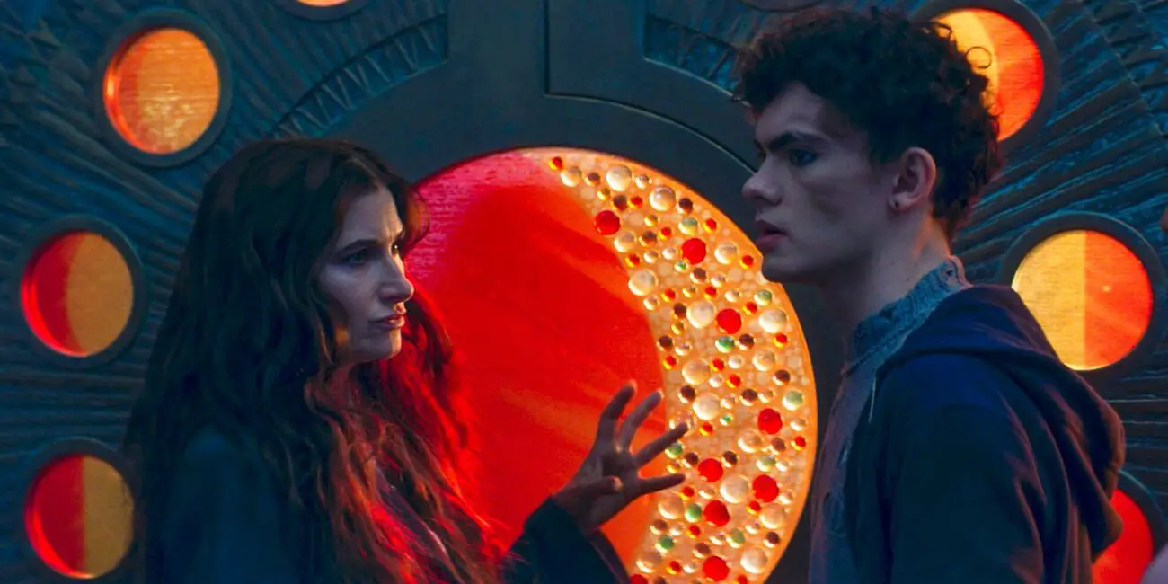 Agath and Teen in front of the door of the second trial with the phases of the moon surrounding the waxing moon.