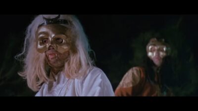 A golden-masked vampire with rotting flesh.