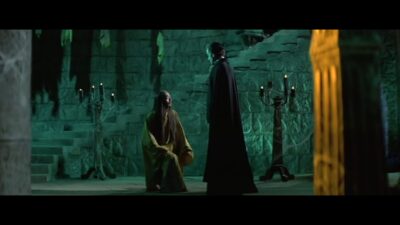 A shaman kneels before Count Dracula.