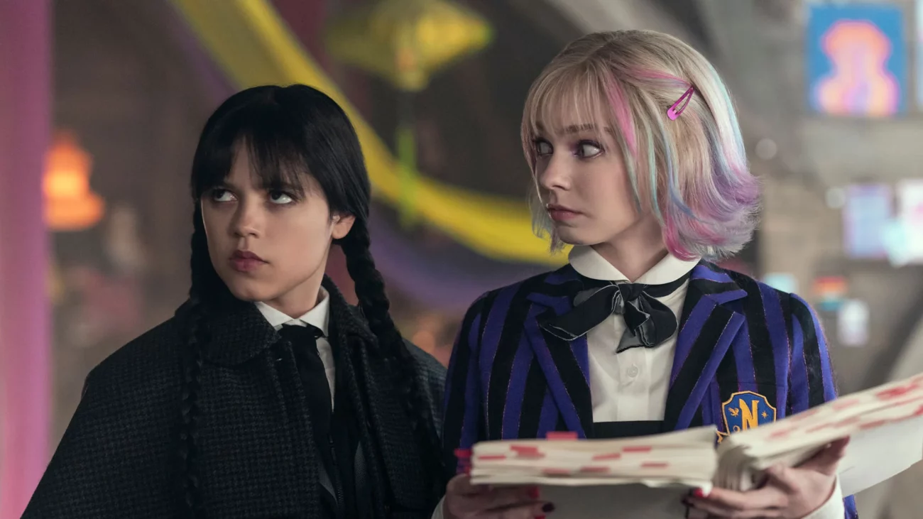 Wednesday and Enid reading Wednesday's novel in the dorm.