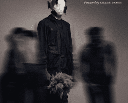 A book cover of a faceless man in the shadows, with the title of the book on the right hand side.